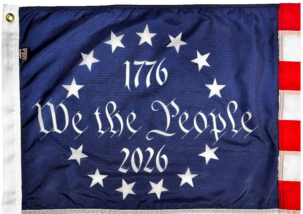 Flag with '1776 We the People 2026' text and stars on a blue background close up