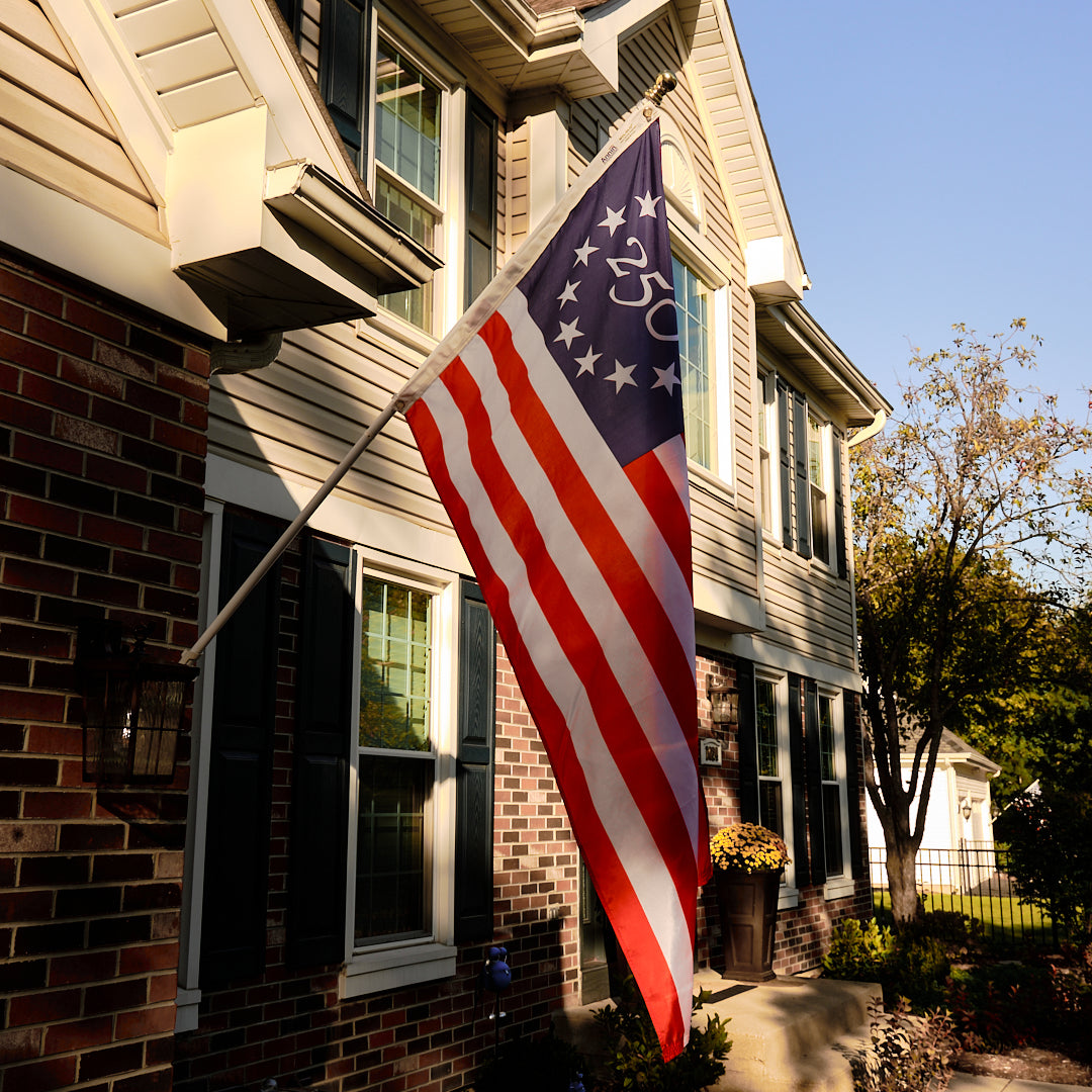 Legacy American flag hanging on residential house